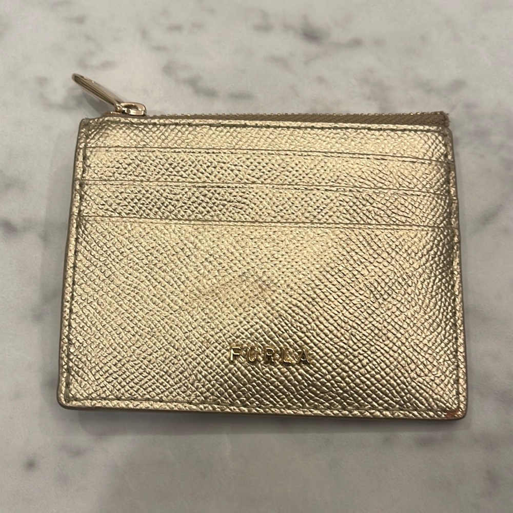 This is an all gold Furla card holder. Great quality.